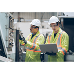 Image of two men in hard hards, safety vests, and goggles, working 
