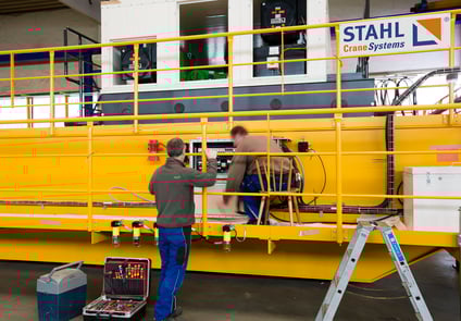 Image of two men working on STAHL Crane system