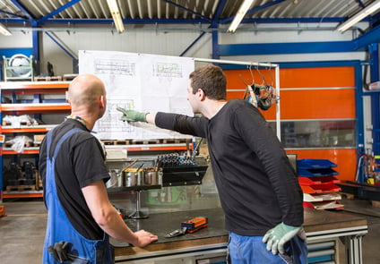 Image Two Men Looking, and pointing at Chart 