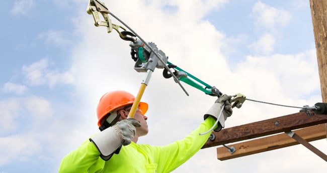 Image of man in Fluorescent Shirt working outside on Utility Application for Power Line