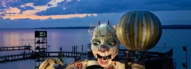 Image of Pfaff-silberblau BETA moving the collar of the Rigoletto on the lake stage at the Bregenz Festival